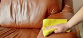 hand wiping couch brown