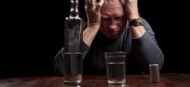 Dark portrait of a man holding his head in despair