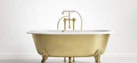 Isolated gold bronze classic bathtub on white wood floor