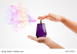 close up of woman hands spraying perfume